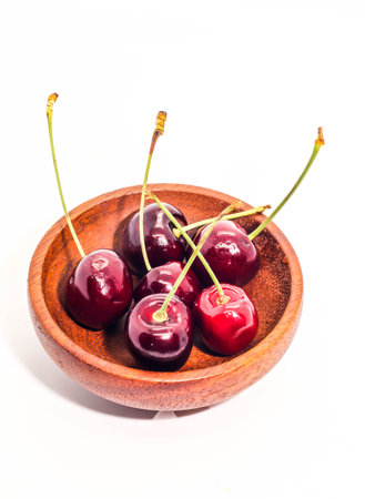 Group Fresh cherry on dark brown wooden cupの写真素材