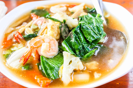 Closeup of Fried noodle with seafood and broccoli on white dishの写真素材