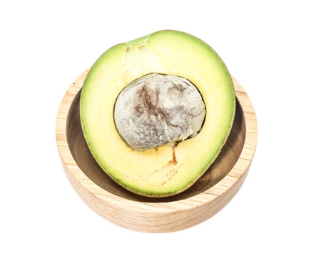 Half seed of green thai avocado on wooden