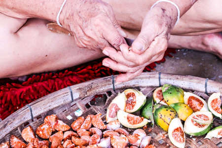 Cutting red Betel nut fresh betel palm on wooden trayの写真素材