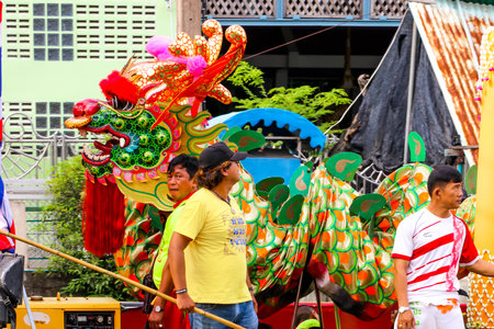 SAMUTSAKORN, THAILAND - JULY 27, Dragon and people in Big Boat of candles Parade to temple at Katumban in Samutsakorn, Thailand on July 27, 2018のeditorial素材