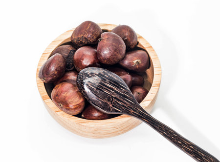 Closeup of brown Chestnuts in the wooden cup with spoonの写真素材