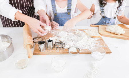 Close up Mom and daughter help preparing the doughの写真素材
