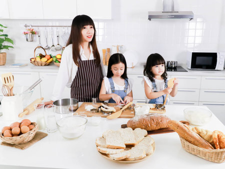 Portrait of little asian girl and mother prepare baking cooking in the kitchenの写真素材