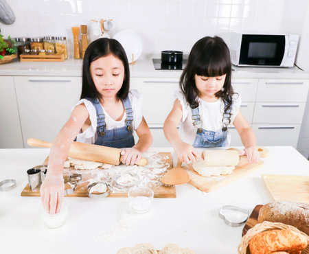 Cute happy little two child have fun baking in the kitchenの写真素材