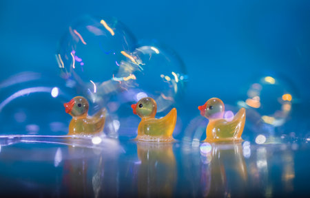 Yellow rubber ducks with bubbles and bokeh. Bathtime!の写真素材