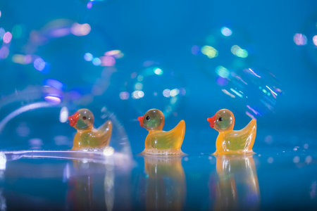 Yellow rubber ducks with bubbles and bokeh. Bathtime!の写真素材
