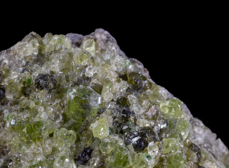 Olivine peridot extreme macro close-up against black background.の写真素材