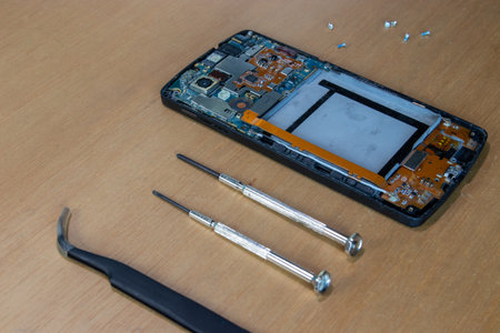 Broken smartphone being repaired at home