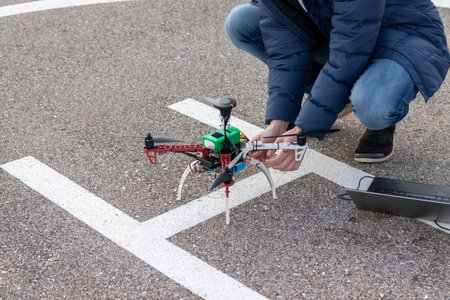Person preparing a drone for flight. Research UAV and laptop ground station.の写真素材