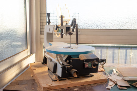 Wood cutting band saw in a workshop with sawdustの写真素材