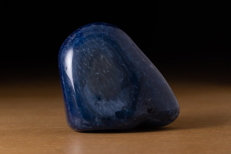 Polished blue agate gemstone from Brazil over a wooden tableの写真素材
