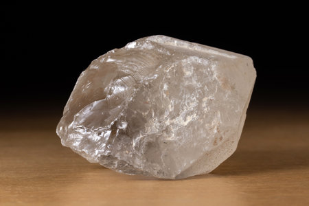 Translucent smoky quartz mineral from Brazil over a wooden tableの写真素材