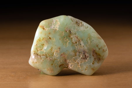 Chrysoprase (chrysoprasus) mineral from Australia over a wooden tableの写真素材