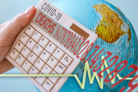 Photo of a calculator with a COVID-19 tittle with deaths counter and big numbers. Also has a vital sign and a world on the background. Perfect for any virus, pandemic theme related to corona virus.の写真素材