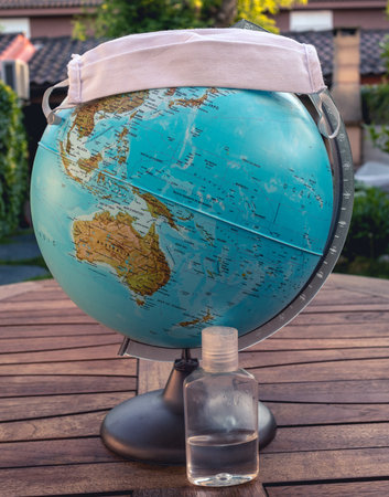 World with a mask and a disinfectant represents the global pandemic