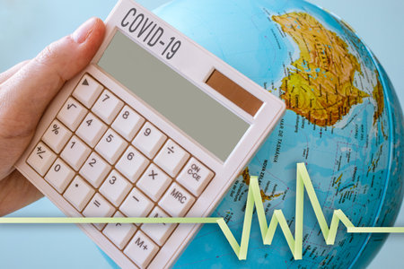 Photo of a calculator with a COVID-19 tittle with a vital sign and a world on the background. Perfect for any virus, pandemic theme.の写真素材