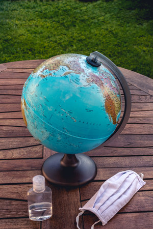 World with a mask and a disinfectant represents the global pandemicの写真素材