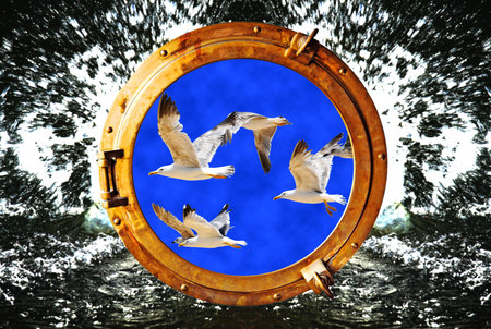 Close-up of a boat closed porthole with flying seagull on black water splash backgroundの写真素材