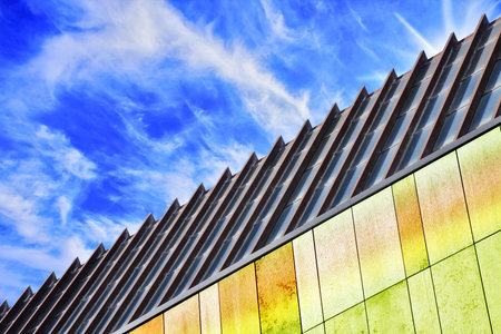 modern architecture of steel and glass with blue sky and wall with various colorsの写真素材