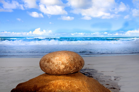 sea with waves and deep blue sky and Two honey colored stone Nature compositionの写真素材