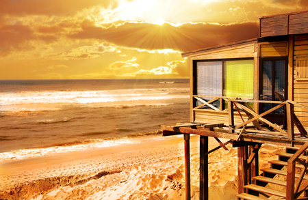 tropical wood house on the sunset の写真素材