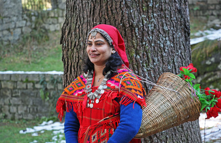 Manali, India December 27, 2013: Adult woman dressed in the traditional tribal attire, pattoo, of Kullu valley in the Himalayan mountain ranges of Indiaのeditorial素材
