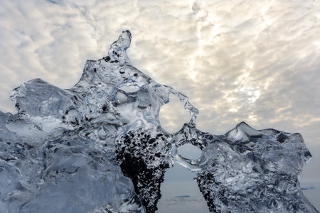 Block of ice melting on the beachの写真素材