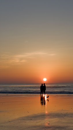 Couple At Sunrise On The Beachの写真素材