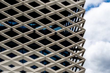 Front of a building with a diamond structure and glass