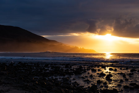 Sunrise on the Pacific with a Mountain in Viewの写真素材