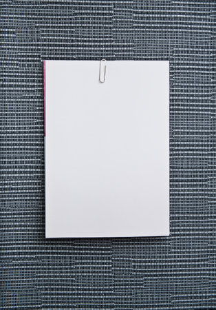 A white note paper on modern wall covering
