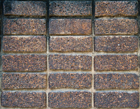 The texture of dark brown laterite stone wall の写真素材