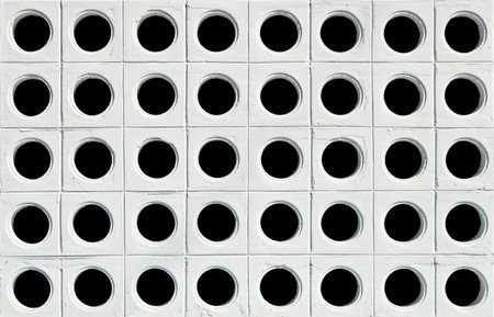 White wall with black holesの写真素材