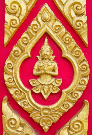 A deity sculpture on Thai temple wallの写真素材