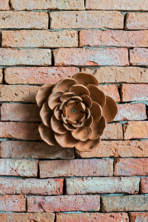 Earthenware flowers on brick wallの写真素材