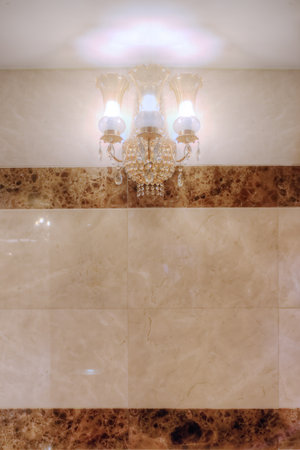 Vintage wall lamp on marble tiles wallの写真素材