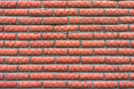 Red wall constructed with cylinder block bricks