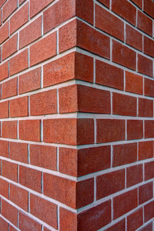 Corner of dark red brick wallの写真素材