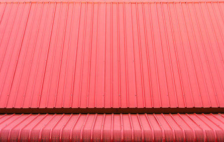 Red corrugated metal sheets roofsの写真素材