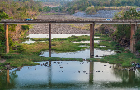 Conceptual image of two cars run into with each other on concrete bridgeの写真素材
