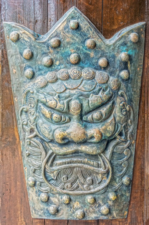 The old vintage Chinese figure of iron monster face for interior designの写真素材