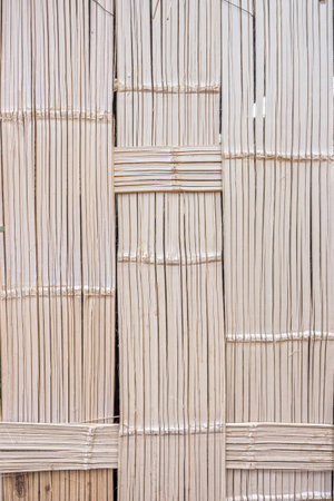 The pattern of bamboo weave wall of traditional bungalow house in countryside, Thailand