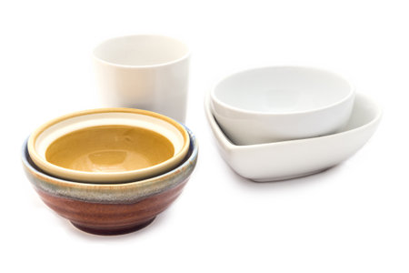 Empty ceramic bowls and cup isolated on white background