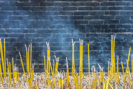 Burning joss sticks and smoke in Buddhist templeの写真素材