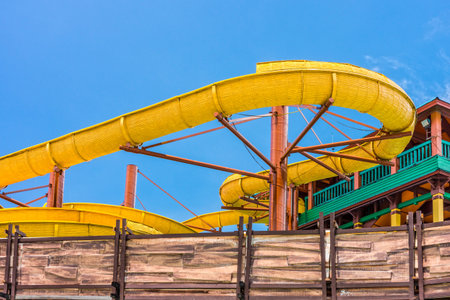 The yellow water slider at outdoor amusement parkのeditorial素材
