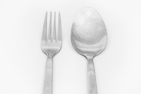 Stainless steel spoon and fork isolated on white backgroundの写真素材
