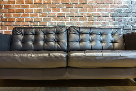 Black leather sofa for interior design in a roomの写真素材