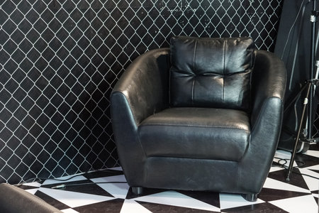 Black leather sofa in studio roomの写真素材