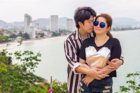 Romantic Asian couple kissing. Happy Thai man and woman at Hua Hin bay, Thailandの写真素材